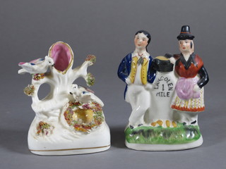 A Staffordshire flat back figure group of a standing lady and gentleman by a milestone marked Lan Colen 1 mile, 4" and a flat  back spill vase decorated a birds nest 4"