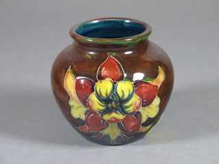 A Moorcroft brown glazed vase decorated columbine, the base impressed Moorcroft England 3"  ILLUSTRATED