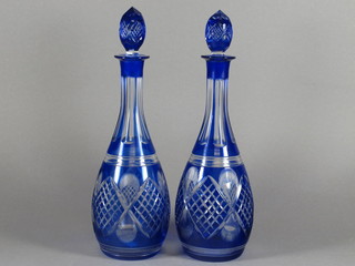 A pair of blue cut glass club shaped decanters and stoppers 12"