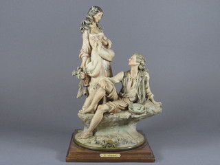 A Capo di Monte figure of lady with fisherman 13" on an oak  base