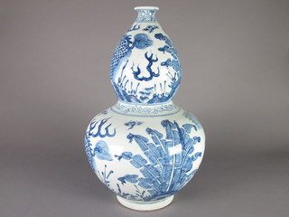 An Oriental blue and white porcelain double gourd shaped vase  21"
