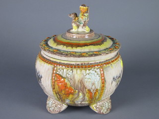 A circular Continental pottery jar and cover, the finial in the  form of a huntsman 14"