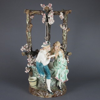 A Victorian pottery figure group of standing lady and gentlemen  by a well 22"