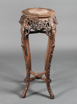 An octagonal pierced hardwood jardiniere stand with veined marble top, raised on cabriole supports 12"w x 36"h