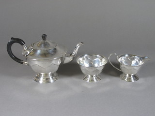 A circular 3 piece silver plated tea service comprising teapot,  cream jug and sugar bowl
