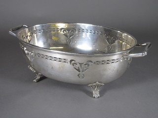 An oval pierced silver plated twin handled dish raised on bracket  feet 9 1/2"