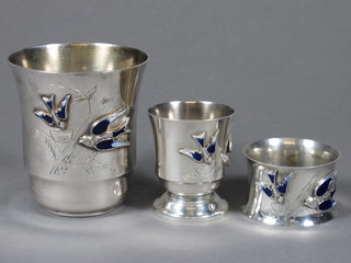 An Art Deco Continental white metal and enamelled Christening set comprising beaker, napkin ring and egg cup, decorated blue  birds