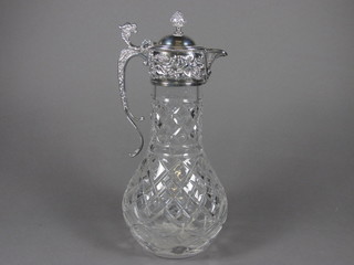 A cut glass claret jug with silver plated mount