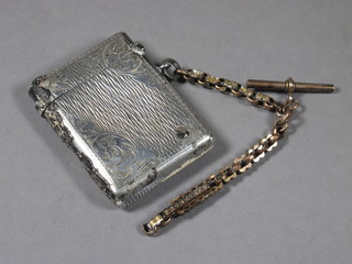 An engraved silver vesta case, Birmingham 1902 hung on a small  section of gilt metal chain