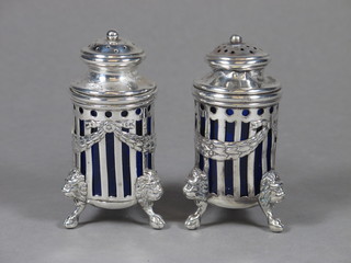 2 Sterling pierced cylindrical pepperettes with blue glass liners