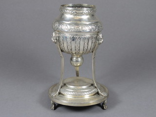 An Eastern embossed white metal urn, raised on 3 shaped feet -  1f, 7"