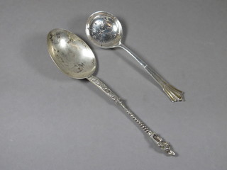 An Edwardian silver sifter spoon Sheffield 1906 and a white  metal apostle spoon