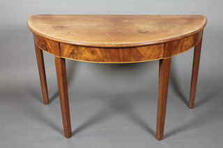 A 19th Century mahogany demi-lune table raised on square  tapering supports 47"w x 27 1/2"h x 26"d