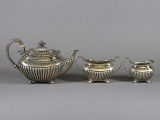 A Victorian silver 3 piece Bachelor's tea service comprising teapot, cream jug and twin handled sugar bowl with demi-reeded  decoration, raised on bun feet Sheffield 1896, 21 ozs   ILLUSTRATED