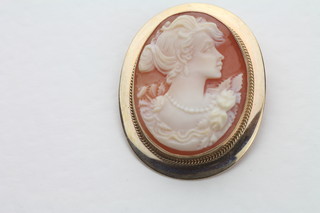 A shell carved cameo portrait brooch contained in a gilt metal  mount