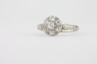 A lady's 18ct white gold cluster dress ring set 7 diamonds