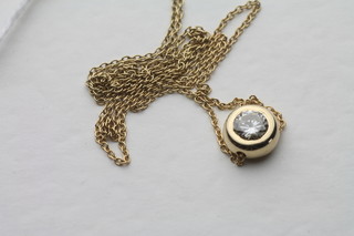 A lady's solitaire diamond pendant hung on a fine gold chain, approx 0.51ct
