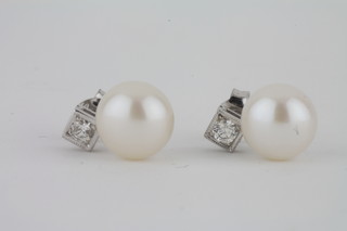A pair of pearl and diamond set ear studs