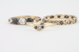 A gold eternity ring set white stones, a gold dress ring set blue  and white stones and 1 other dress ring