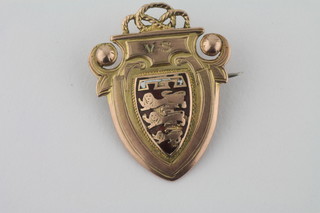 A 9ct gold and enamelled shield shaped sporting medal
