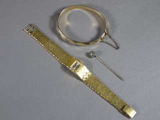 A lady's gilt metal bracelet, a lady's wristwatch and a stick pin