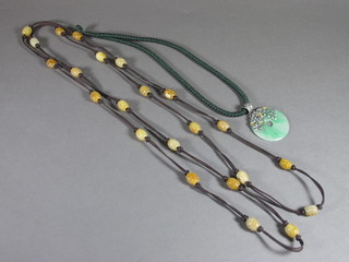 A green hardstone pendant and an Oriental hardstone necklet