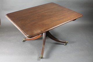 A 19th Century mahogany rectangular snap top breakfast table  raised on a gun barrel and tripod base ending in brass caps and  castors 48"w x 37"d