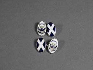 A pair of silver and enamelled cufflinks decorated Scottish coat of arms