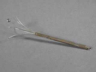 A silver swizzle stick