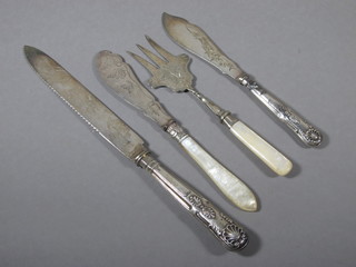 A silver handled bread knife, a silver handled butter knife and a mother of pearl handled bread knife and butter knife