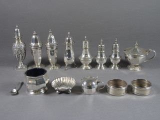 6 various silver pepperettes, 2 silver napkin rings, a silver scallop  shaped salt, a condiment spoon, a silver salt and 2 mustards, 12  ozs