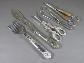 A pair of silver plated fish servers and 3 silver plated pairs of grape scissors