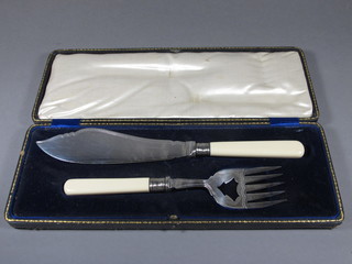 A pair of silver plated fish servers, cased