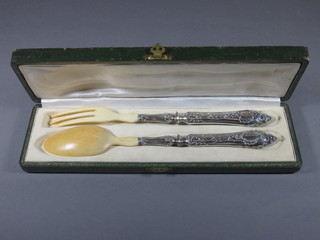 A pair of Continental horn and silver mounted salad servers,  cased