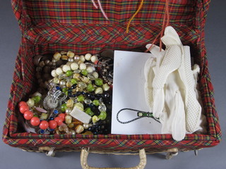 A wicker box containing a collection of costume jewellery