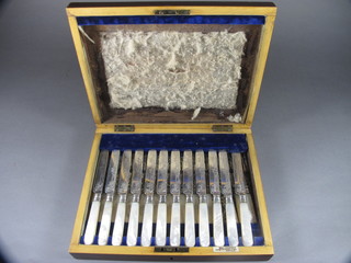 A set of 12 Victorian silver plated fruit knives and forks with mother of pearl handles, Sheffield 1909, contained in a  mahogany case