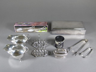 A rectangular plain silver plated cigarette box with hinged lid 9", 2 silver plated sauce boats, plated tongs, 2 silver plated toast  racks, a table lighter etc
