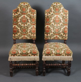 A pair of 17th/18th Century style oak high back chairs with upholstered seats and backs, on turned supports