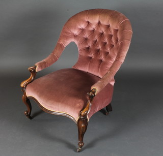 A Victorian mahogany show frame open arm chair upholstered in pink buttoned material
