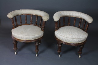 A pair of Victorian oak tub back armchairs with spindle  decoration, on turned supports
