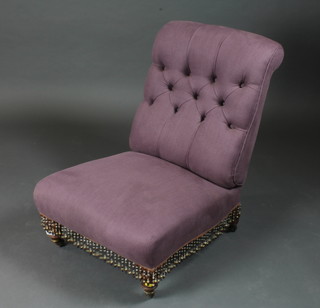 A Victorian nursing chair upholstered in purple material