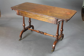 A Victorian rectangular rosewood library table raised on turned supports with H framed stretcher 48"w x 22"d x 28"h