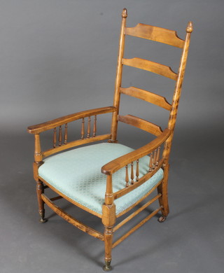 An Edwardian beech ladderback open arm chair with bobbin turned decoration