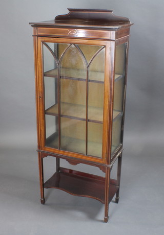 An Edwardian inlaid mahogany display cabinet with raised back,  the shelved interior enclosed by astragal glazed door, on square  tapering supports 24"w x 12"d x 58"h