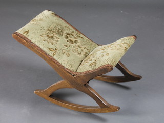 An oak framed rocking gout stool