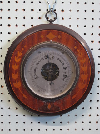 An aneroid barometer with silvered dial contained in a circular inlaid mahogany case 9"