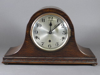 A chiming mantel clock with silvered dial and Arabic numerals contained in an oak Admirals hat shaped case
