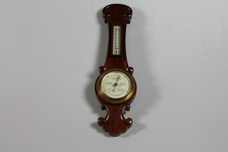 An aneroid barometer and thermometer contained in a mahogany  wheel case