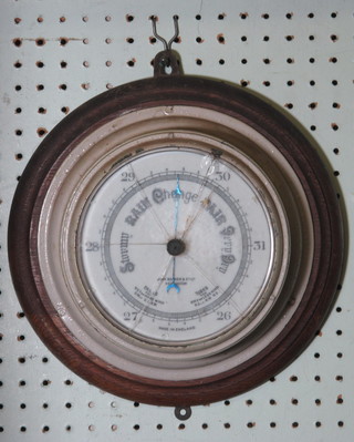 An aneroid barometer with 7" porcelain dial by John Barker &  Co. of Kensington, glass f,