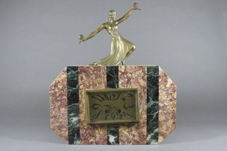 An Art Deco French 8 day mantel clock with a rectangular  painted dial with Arabic numerals contained in a 2 colour marble  case surmounted by a spelter figure of a dancing lady